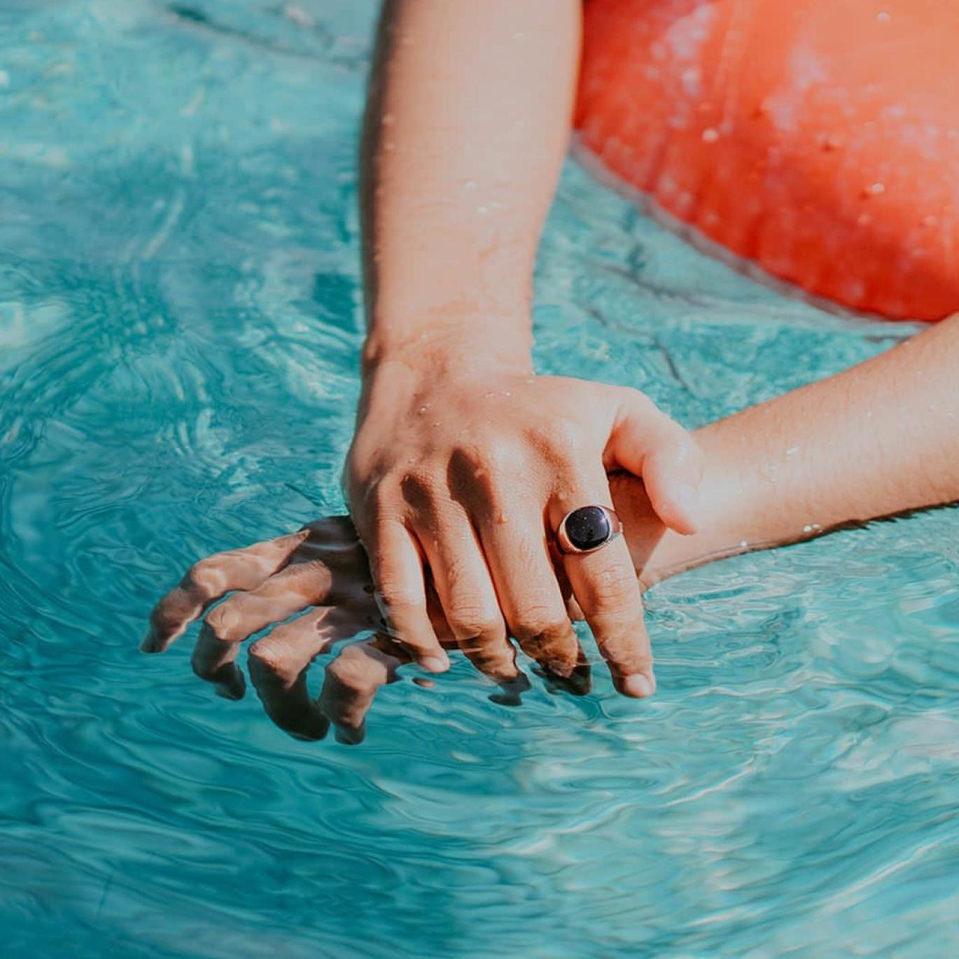 woman relaxes on a floatie in swimming pool